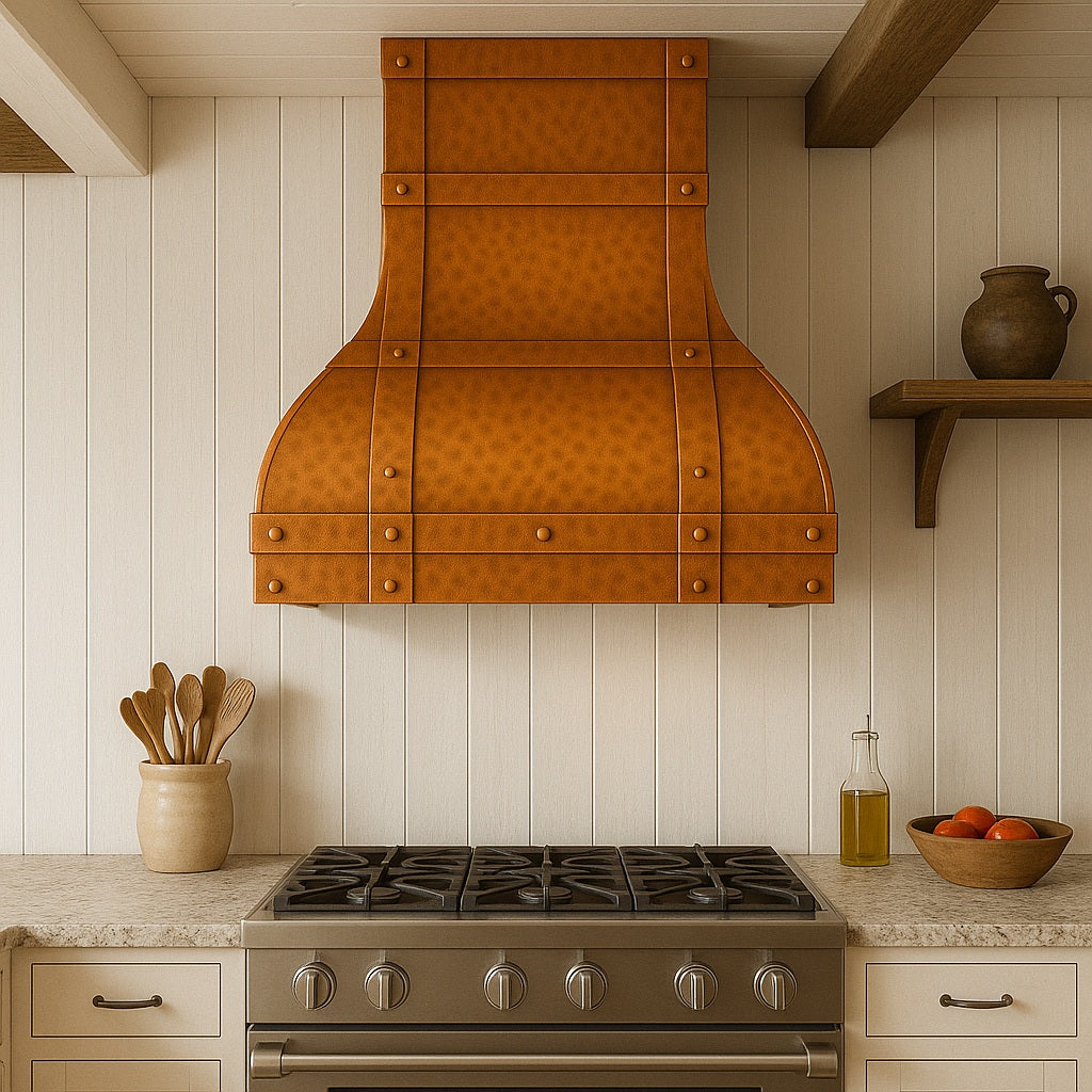 Rustic farmhouse kitchen furnished with a wall-mount arched hammered copper range hood with riveted strap detailing