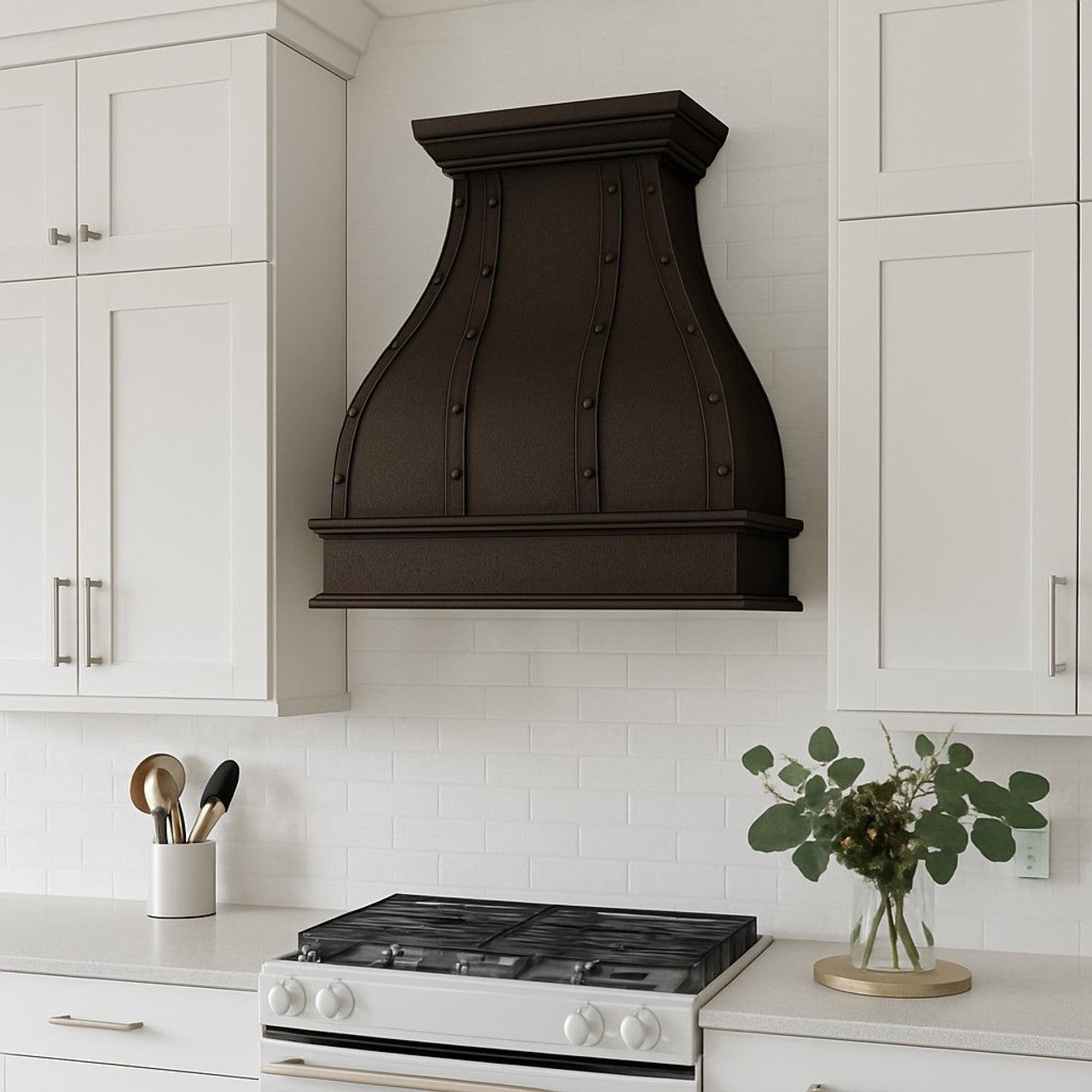 Dark patina copper range hood with straps and rivets in a transitional suburban house kitchen