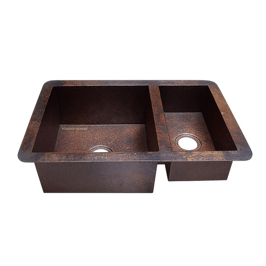 Front view of a custom drop in undermount copper kitchen sink with larger left bowl