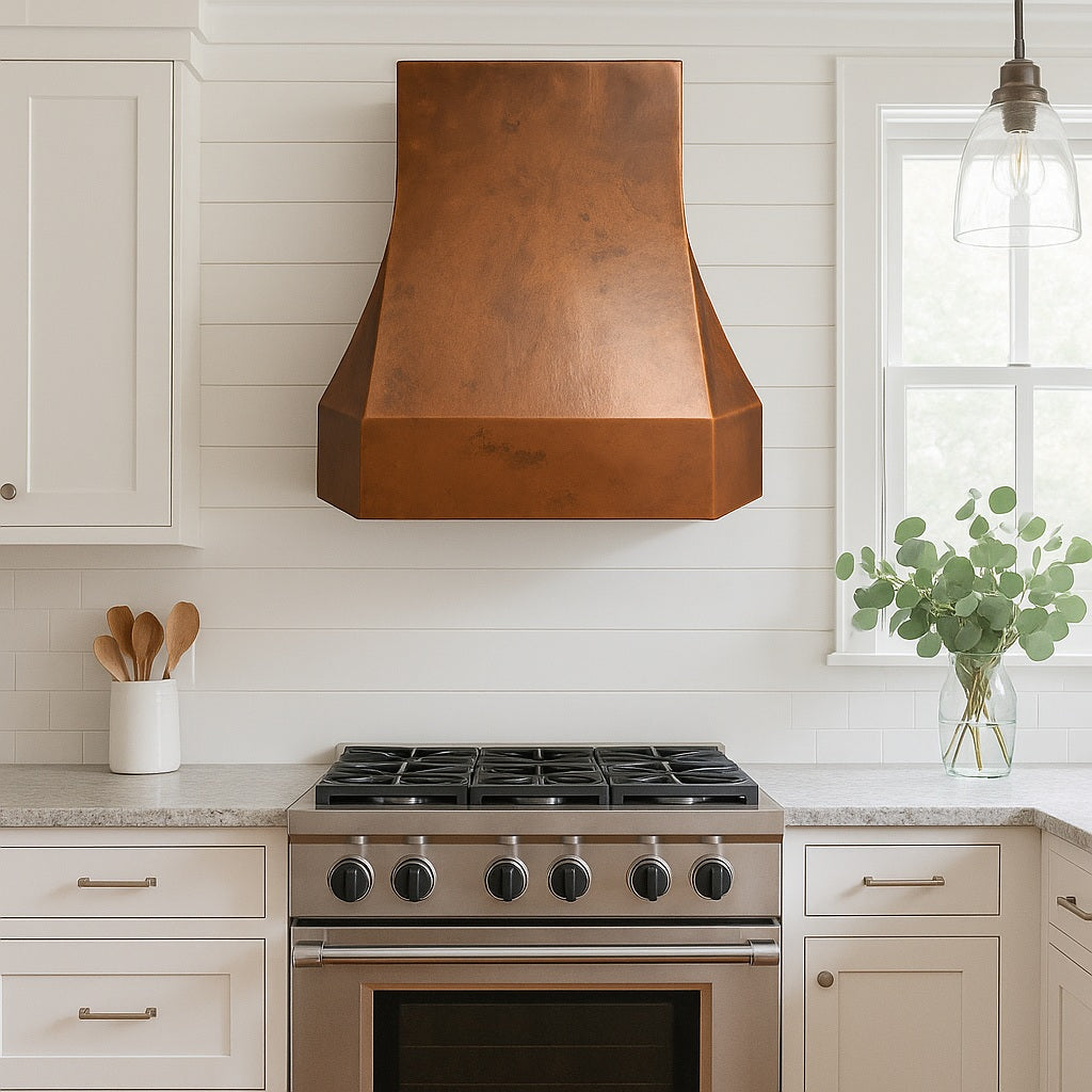 Modern tapered copper range hood with smooth patina finish in a transitional style kitchen