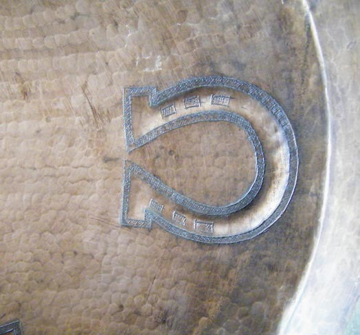 horseshoe pattern hand hammered inside the oval sink for a bathroom in antique style