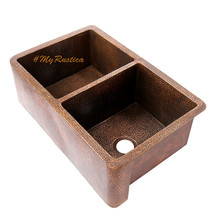 Bronze double basin kitchen sink with '#MyRustica' branding on a white background