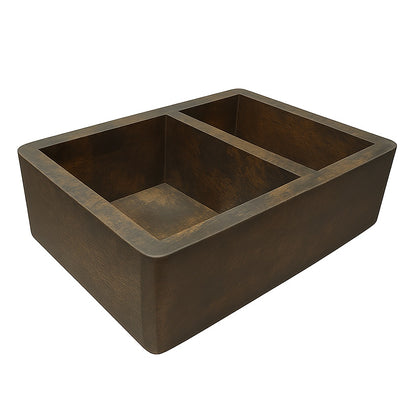 Side view of a custom apron copper kitchen sink with larger left bowl and smaller right bowl 
