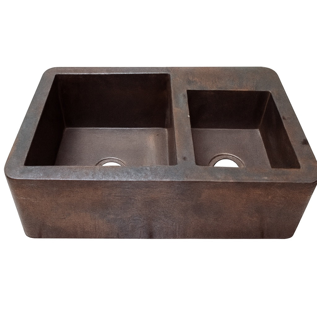 Front view of a custom apron copper kitchen sink with large left and smaller right bowl