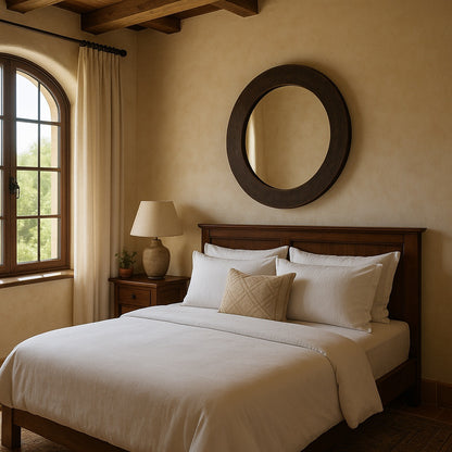 Bedroom with a custom hand-hammered round copper mirror