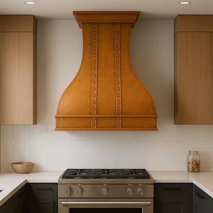 Curved shape copper range hood with smooth design in a contemporary style kitchen setting