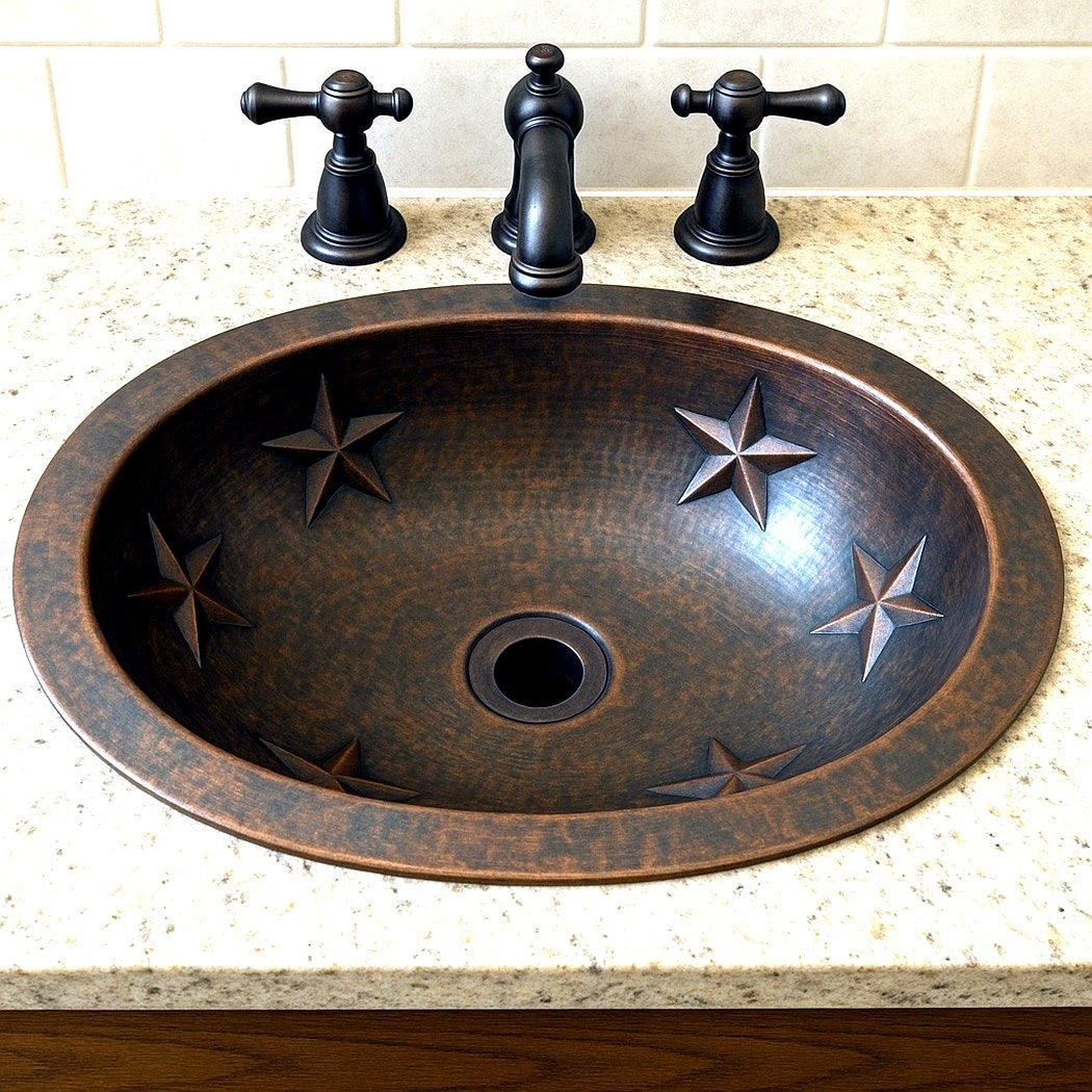 Custom oval copper bathroom sink with embossed Texas stars in a log cabin vanity setting