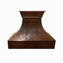 Copper range hood with rivet details on a white background