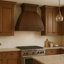 Hacienda copper range hood with grapevine apron design in a traditional style kitchen