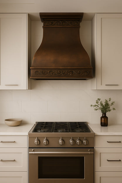 Hacienda copper range wall-mount hood with decorative scrollwork apron in a modern style kitchen