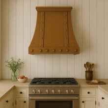 Hacienda style copper kitchen range hood with rivets 30-inch in a rustic kitchen