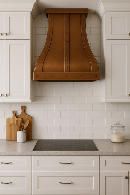 Hammered copper range hood with straps and rivets in a transitional kitchen settings