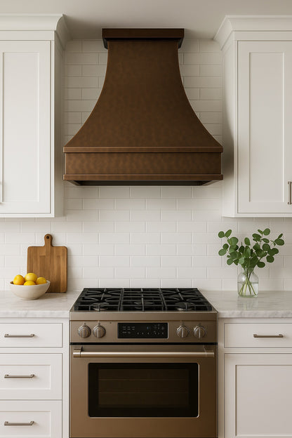 Hammered copper range hood with trapezoid design in a modern kitchen