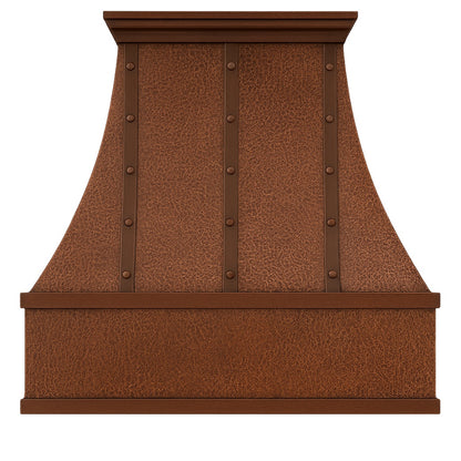 Hammered copper range hood with vertical riveted straps seen from the front