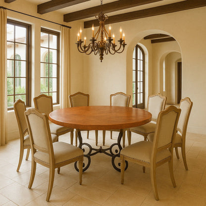 Large round handcrafted copper table in dining room, hammered top with warm patina on Spanish Colonial iron stand base