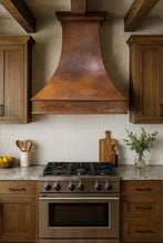 Mexican hacienda style smooth copper range hood 42-inch in a transitional style kitchen with wood cabinets and white ceramic tiles
