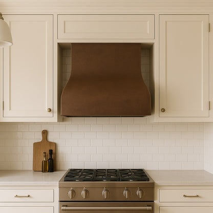 Minimalist curved copper range hood with smooth patina finish in under-cabinet version in a transitional style kitchen