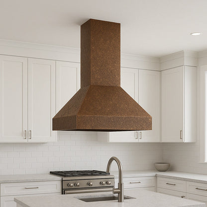 Minimalist hammered copper range hood in a kitchen island configuration