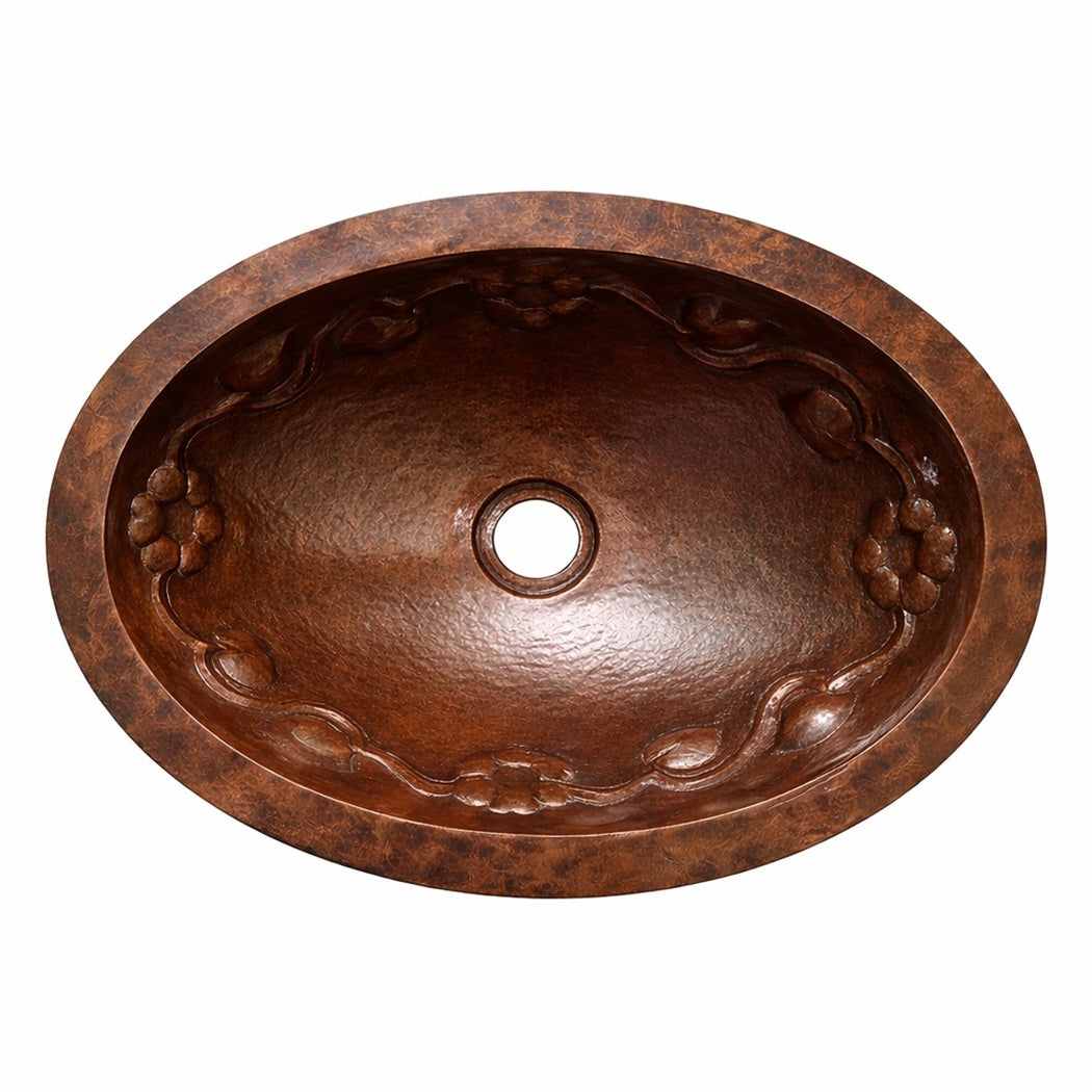 Oval hammered copper drop-in bathroom sink with decorative relief