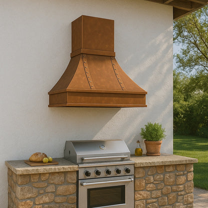 Riveted flared custom 48-inch copper range hood with crown molding design venting an outdoor kitchen above a gas bbq