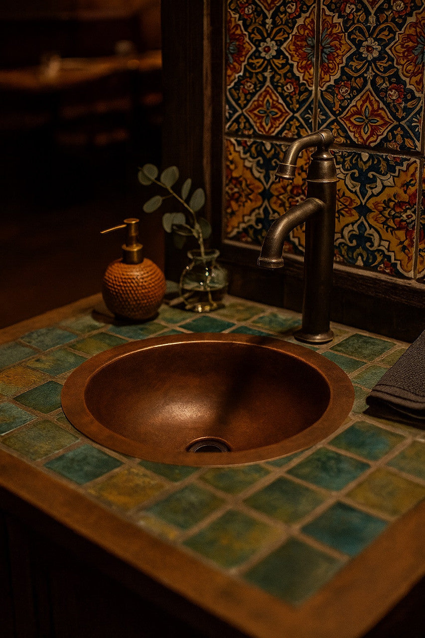 Custom round copper sink with wide rim in a hacienda style bathroom