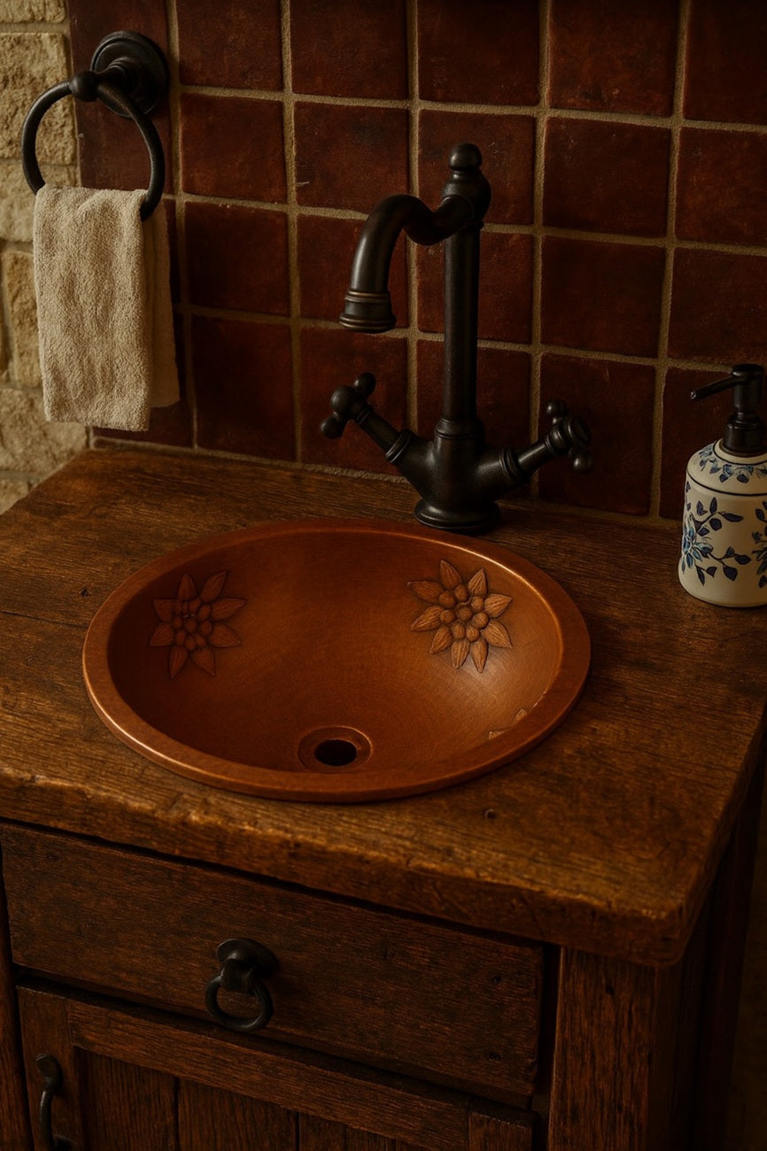Rustic bathroom with a round hammered copper bathroom sink with floral relief design