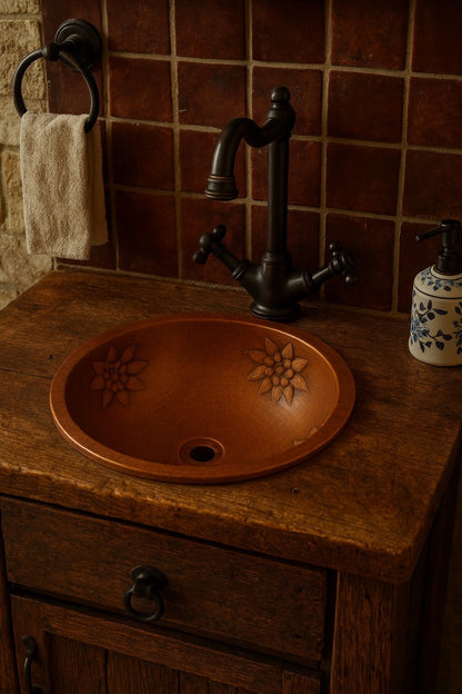 Rustic bathroom with a round hammered copper bathroom sink with floral relief design