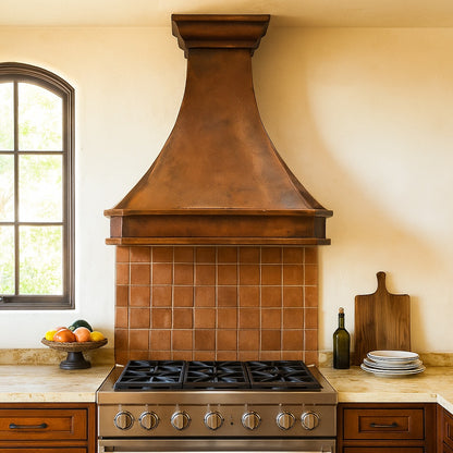 Southeastern style kitchen with an antique flared copper range hood with a stepped crown design