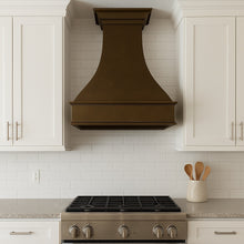 Spanish Revival hammered copper range hood in a transitional style kitchen