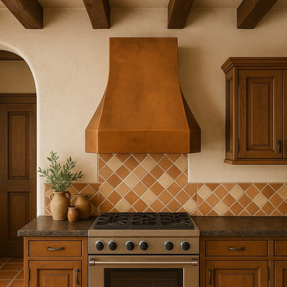 Modern tapered copper range hood with smooth patina finish in a Spanish mission style kitchen