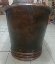 front view of a small copper bathtub